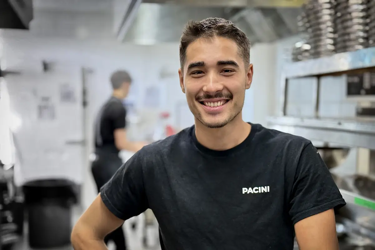 PACINI chef preparing a dish in the kitchen.